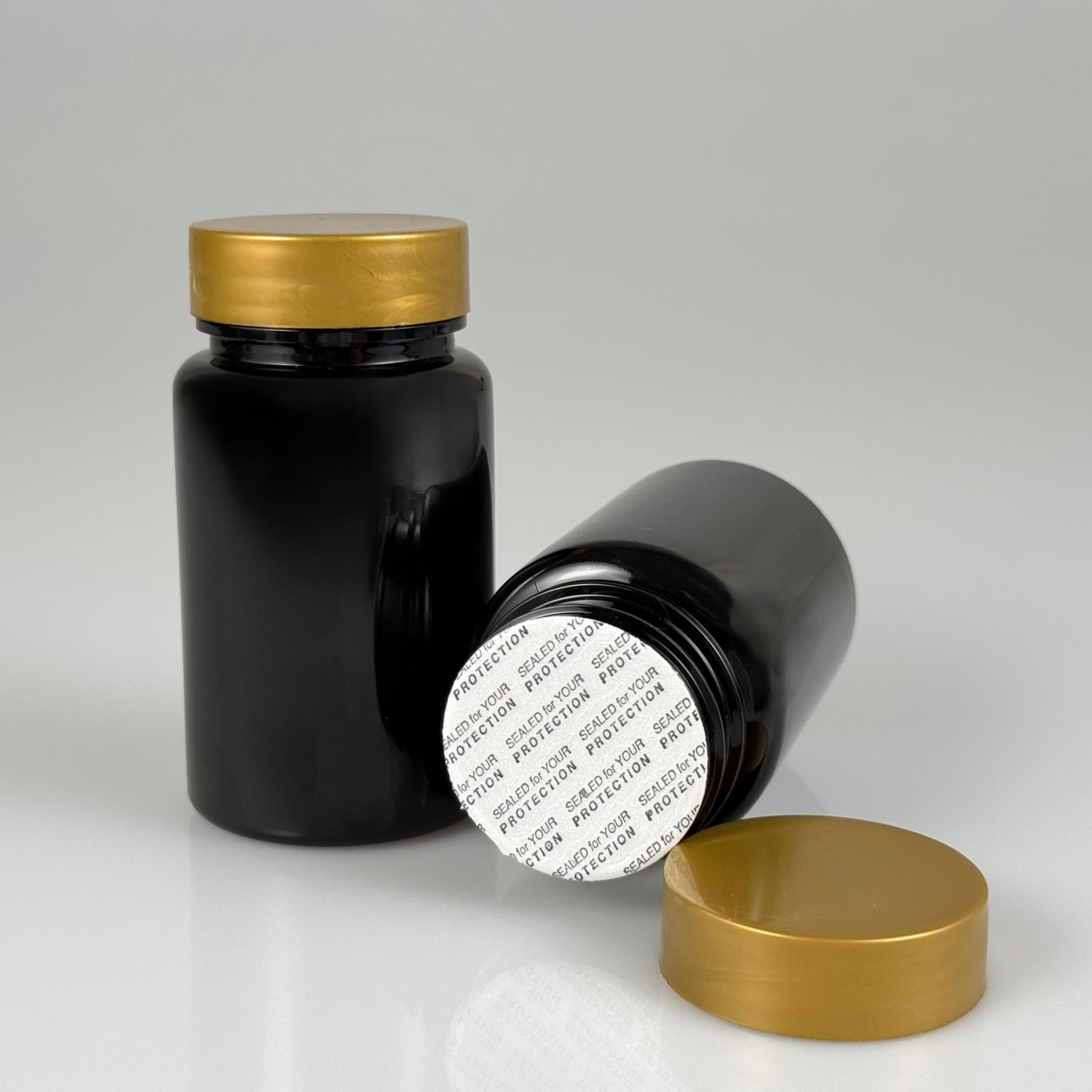 100 CC SİYAH PET TABLET ŞİŞESİ - GOLD KAPAKLI + KENDİNDEN YAPIŞKANLI KÖPÜK CONTALI - 100 ML KAPSÜL KUTUSU - İLAÇ ŞİŞESİ - MEDİKAL HAP ŞİŞESİ - FARMASÖTİK KAVANOZ