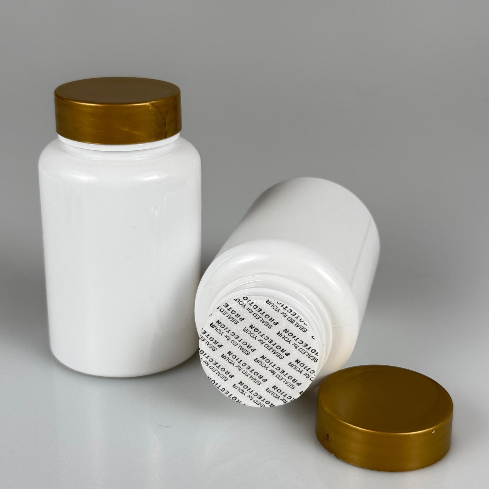 150 CC BEYAZ PET TABLET ŞİŞESİ - GOLD KAPAKLI + KENDİNDEN YAPIŞKANLI KÖPÜK CONTALI - 150 ML KAPSÜL KUTUSU - İLAÇ ŞİŞESİ - MEDİKAL HAP ŞİŞESİ - FARMASÖTİK KAVANOZ